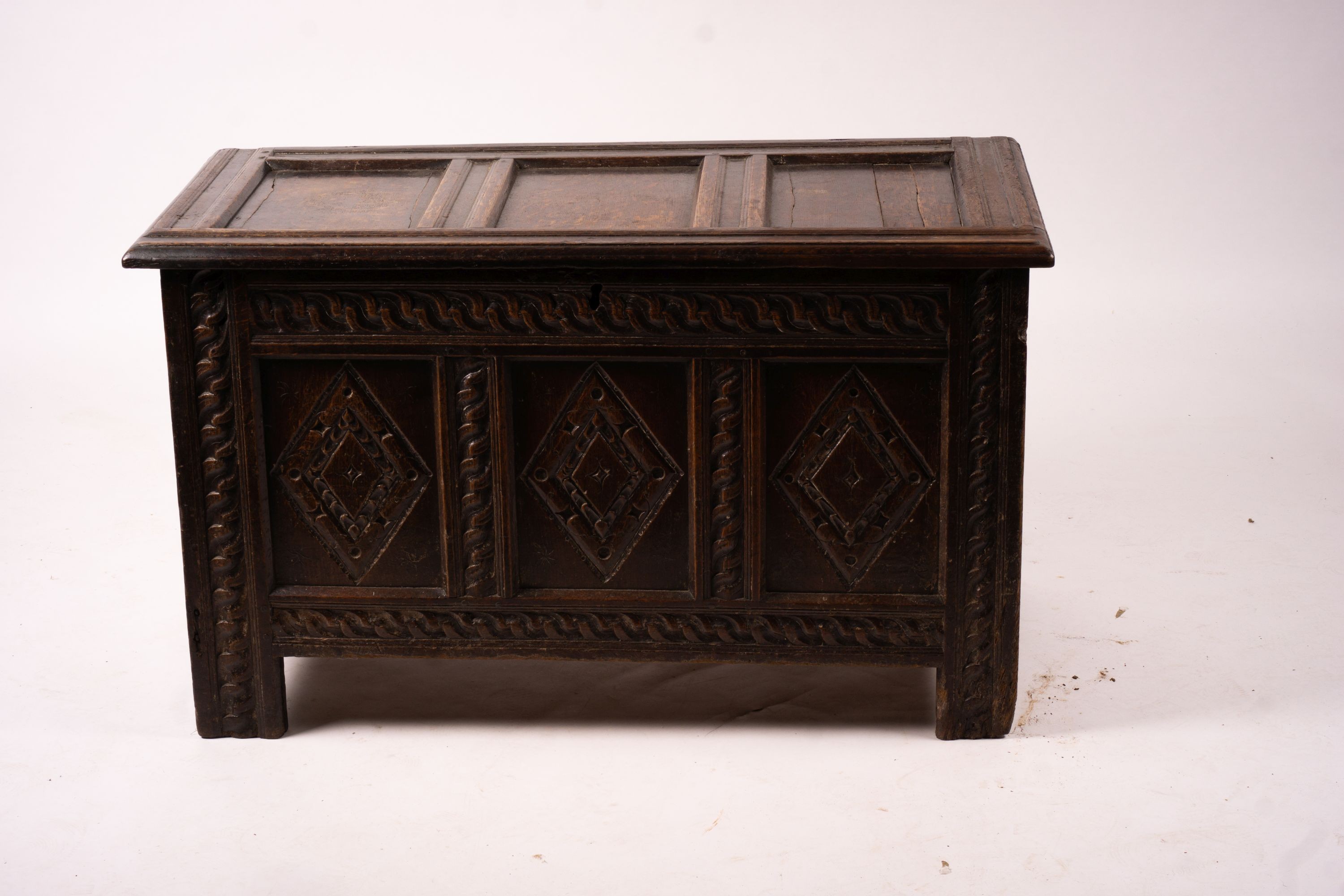 A 17th century carved panelled oak coffer, length 115cm, depth 56cm, height 67cm